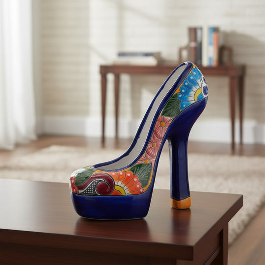 The Talavera Hub handcrafted ceramic high heel statue featuring vibrant multicolor floral patterns on a blue base.