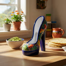 The Talavera Hub handcrafted ceramic high heel statue featuring vibrant multicolor floral patterns on a kitchen counter.