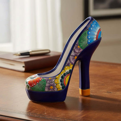 The Talavera Hub handcrafted ceramic high heel statue featuring a vibrant multicolor floral pattern on a blue base.