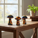 The Talavera Hub set of 3 ceramic mushrooms, hand-painted with sunflowers and green leaves on a dark blue background.