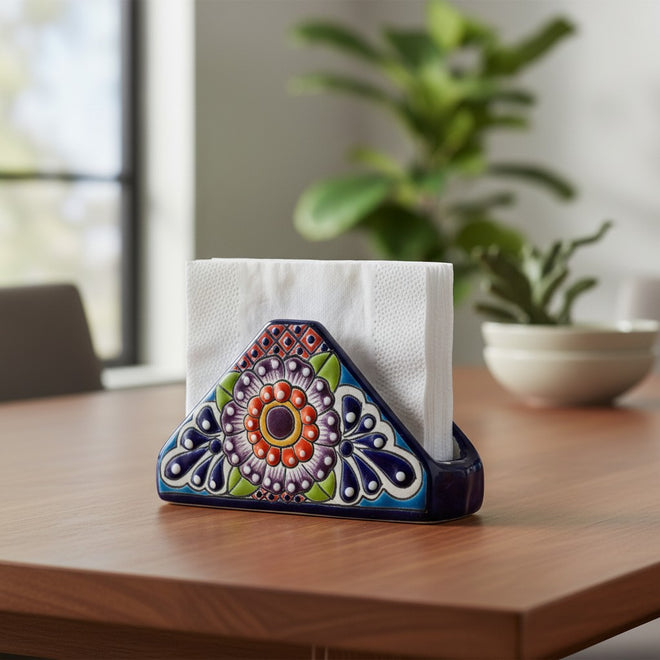 The Talavera Hub hand-painted ceramic napkin holder featuring a triangular shape and vibrant floral Mexican folk art.