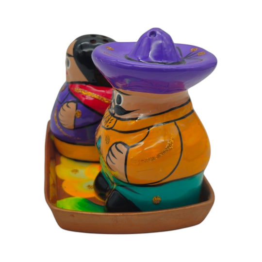 The Talavera Hub hand-painted ceramic salt and pepper shakers featuring a couple on a matching tray in vibrant colors.