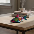 The Talavera Hub handcrafted ceramic shark figurine with vibrant Mexican folk-art floral patterns on a wooden table.