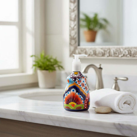 The Talavera Hub hand-painted ceramic soap dispenser with vibrant floral patterns on a marble bathroom vanity.