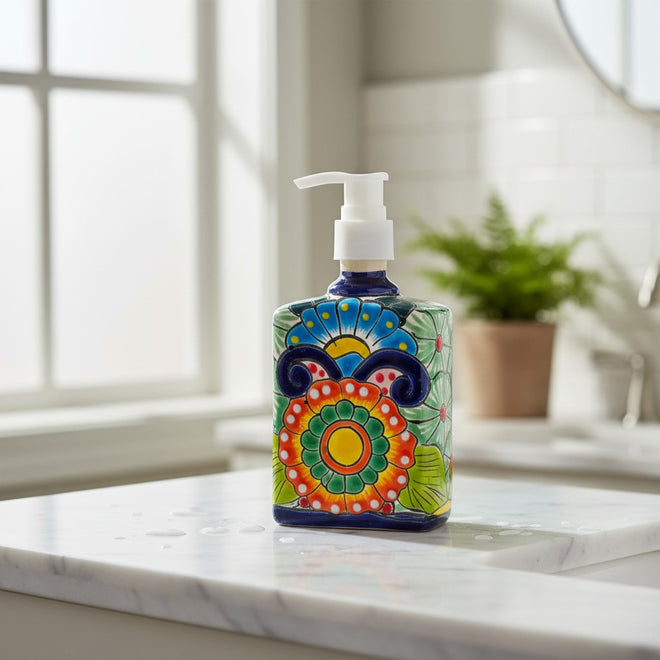 The Talavera Hub hand-painted ceramic soap pump with colorful Mexican floral patterns on a marble bathroom countertop.