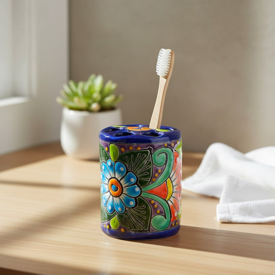 The Talavera Hub handcrafted ceramic toothbrush holder with vibrant floral patterns and a cobalt blue rim.