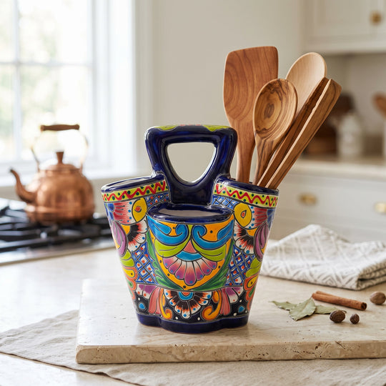 The Talavera Hub hand-painted ceramic utensil holder with vibrant floral patterns and three compartments on a counter.