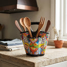 The Talavera Hub hand-painted ceramic utensil holder with vibrant floral patterns and three compartments on a counter.
