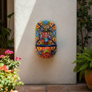 The Talavera Hub handcrafted ceramic wall fountain with frog spout, featuring vibrant floral and geometric patterns in orange, blue, red, yellow, and green.