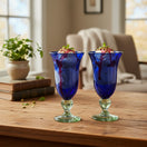 The Talavera Hub two hand-blown cobalt blue glass goblets with clear textured stems and bases. Perfect for desserts.