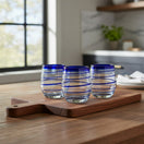 The Talavera Hub hand-blown stemless wine glasses with cobalt blue spiral design. Set of 4, 12 oz capacity.