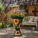 The Talavera Hub Cobalt Blue Sunflower Pedestal Planter, a large ceramic garden pot with hand-painted sunflowers and white dots.
