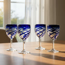 The Talavera Hub hand-blown Mexican wine glass with cobalt blue swirls and a clear stem. 12 oz.