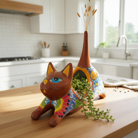 The Talavera Hub handcrafted ceramic cat planter, hand-painted with colorful flowers and patterns in green, blue, red, and yellow.