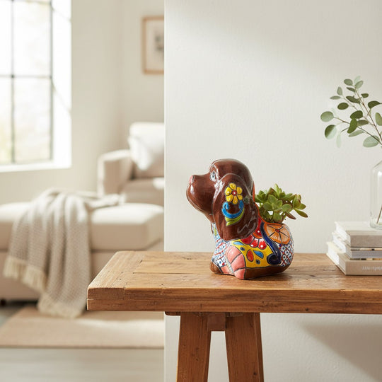 The Talavera Hub medium brown Talavera dog statue with colorful floral and geometric patterns. Hand-painted ceramic.