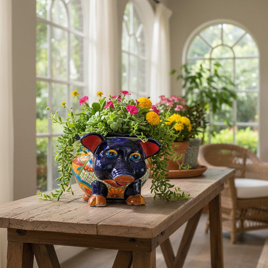 The Talavera Hub hand-painted ceramic pig planter with colorful floral patterns and red ears. Ideal for succulents or herbs.