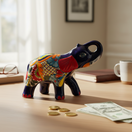 The Talavera Hub handmade blue ceramic elephant coin bank with colorful floral Talavera patterns and red accents.