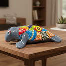 The Talavera Hub medium grey ceramic seal statue with colorful Talavera floral and scroll patterns.