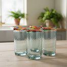 The Talavera Hub hand-blown clear glass tumbler with a colorful confetti rim, 18 oz capacity.
