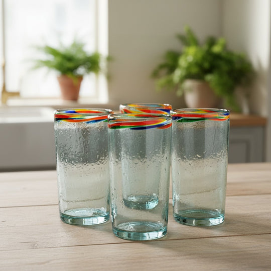 The Talavera Hub hand-blown clear glass tumbler with a colorful confetti rim, 18 oz capacity.