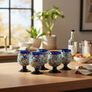 The Talavera Hub blue rim confetti rock shot glass with pedestal base, hand-blown recycled glass.