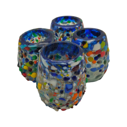 The Talavera Hub Confetti Rimmed Shot Glass with blue rim and multicolor glass flecks. Hand-blown recycled glass.