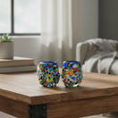The Talavera Hub confetti rimmed shot glass with blue rim, hand-blown recycled glass with multicolor flecks.