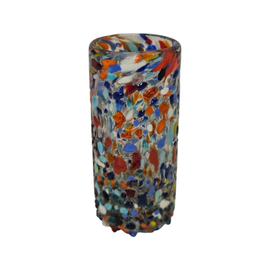 The Talavera Hub hand-blown double shot glass with colorful confetti pattern. Clear glass with embedded flecks of blue, orange, red, and white.