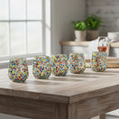 The Talavera Hub hand-blown stemless wine glasses with colorful confetti pattern and pebbled texture. Set of 6, 12oz capacity.