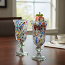 The Talavera Hub Hand-Blown Mexican Sundae Glasses with confetti design in red, blue, orange, and green speckles. Flared rim, pedestal base, 7" tall.