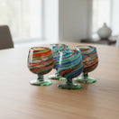 The Talavera Hub Hand-Blown Mexican Shot Glass with confetti swirl design in red, blue, green, and amber glass.