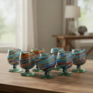 The Talavera Hub Hand-Blown Mexican Shot Glass with confetti swirl design in red, blue, green, and amber.