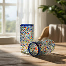 The Talavera Hub hand-blown glass tumbler with confetti pattern and blue rim. Clear glass with colorful chips and pebbled texture.