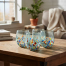 The Talavera Hub hand-blown stemless wine glass with confetti design in red, blue, orange, and green speckles. Clear recycled glass, 12 oz capacity.