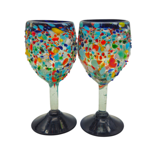 The Talavera Hub hand blown Mexican wine glasses with blue rim and colorful confetti design. Lead-free glass.