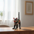 The Talavera Hub handmade ceramic cat statue, arched pose, vibrant Day of the Dead folk art style with floral and skull motifs.