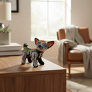 The Talavera Hub hand-painted ceramic Chihuahua statue with Day of the Dead motifs, featuring floral designs and skeletal details.