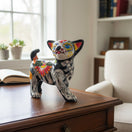 The Talavera Hub hand-painted ceramic Chihuahua statue with Day of the Dead motifs, featuring floral designs and skeletal patterns.