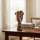 The Talavera Hub ceramic planter features a half-and-half face design with one side natural and the other a Day of the Dead skull motif with sunflowers.
