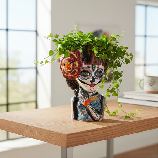 The Talavera Hub handmade ceramic Day of the Dead face planter, featuring a female sugar skull with floral patterns and a large red flower.