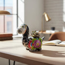 The Talavera Hub black ceramic brachiosaurus planter with Day of the Dead skull face and floral motifs in vibrant colors.