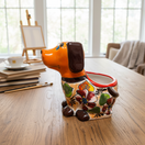 The Talavera Hub medium orange dog planter hand-painted with colorful flowers and brown details.