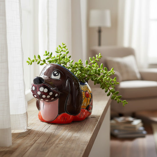 The Talavera Hub small hand-painted Mexican ceramic dog planter with a succulent on a wooden windowsill