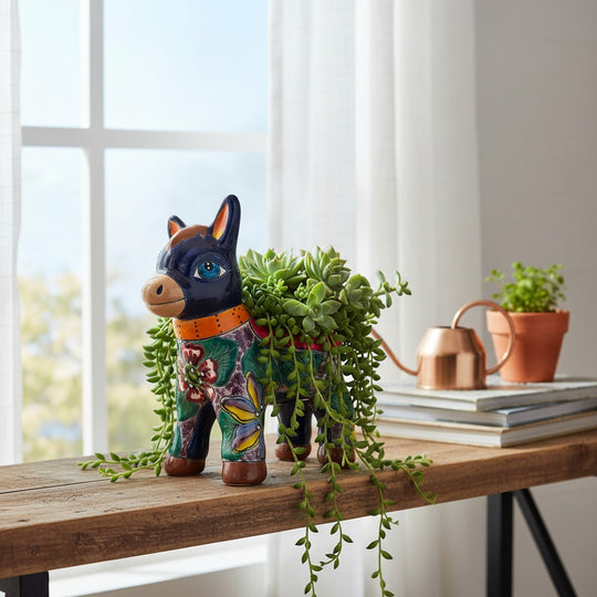 The Talavera Hub vibrant Mexican donkey planter, handcrafted ceramic with hand-painted floral patterns in blue, green, yellow, and red.