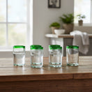The Talavera Hub hand-blown Mexican tumbler glass with clear body and emerald green rim, 5" tall, set of 6.
