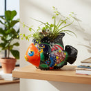 The Talavera Hub hand-painted ceramic fish planter in vibrant orange, blue, and floral designs. Features a playful fish shape with detailed fins and a lead-free glaze.