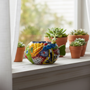 The Talavera Hub small green fish planter, hand-painted with colorful floral and geometric patterns, ceramic pottery.