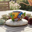 The Talavera Hub small green fish planter, hand-painted with colorful floral and geometric patterns, made of pottery.