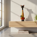 The Talavera Hub tall cat statue with a black head and vibrant floral terracotta body on a wooden shelf.