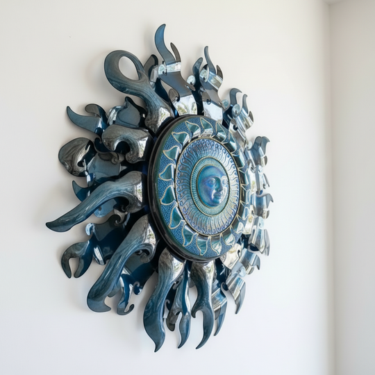 The Talavera Hub Giant Sun Wall Art, a large blue metalwork sculpture with a radiant sun face and detailed rays, featuring a built-in light fixture.